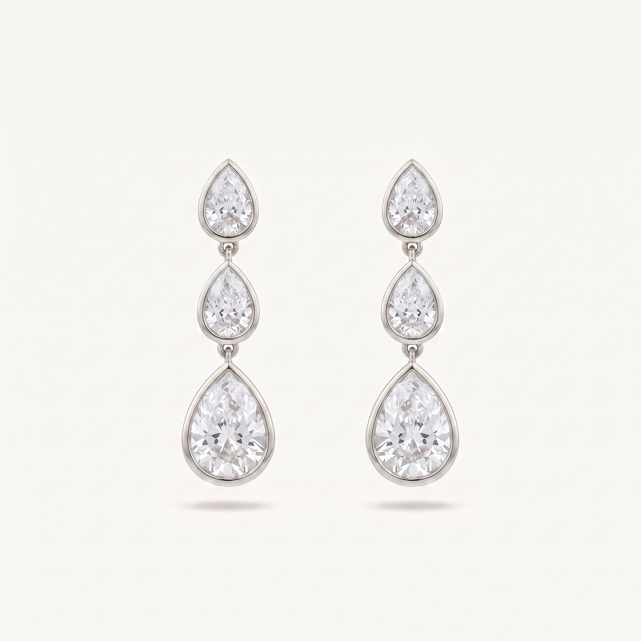 Graduated Pear Diamond Drop Earrings bezel-set pears in white gold