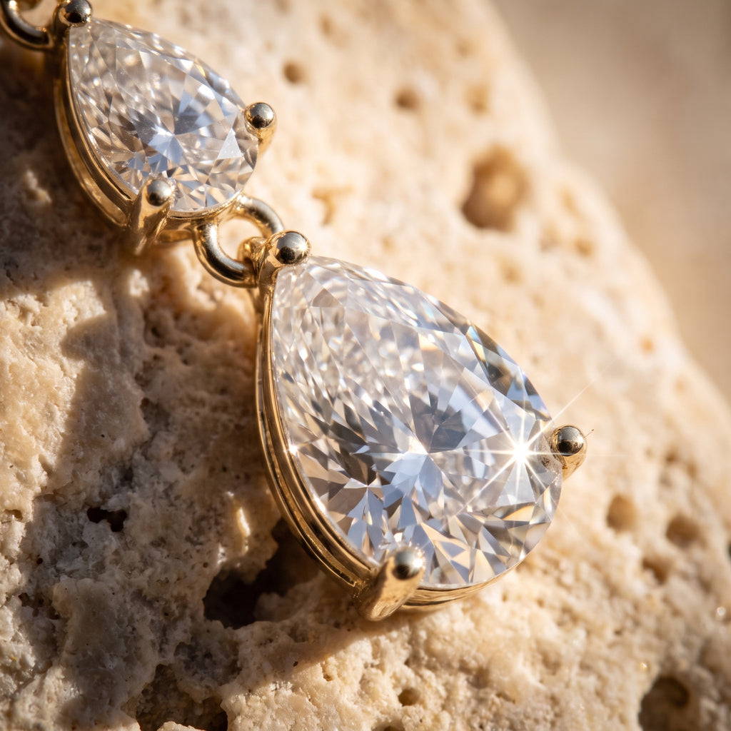 Macro detail of the two lower pear-cut lab-grown diamonds and 14k gold bead prongs on Leah's Ascent