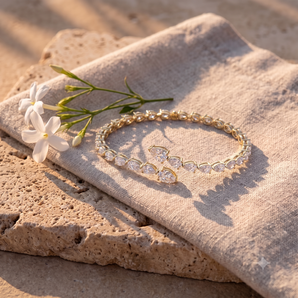 Leah's Bangle in 14k yellow gold on raw linen with jasmine in late afternoon light