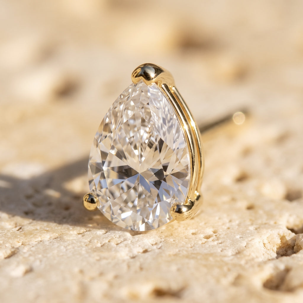 Macro detail of Leah's Tear: pear-cut diamond in three yellow gold claws, point up
