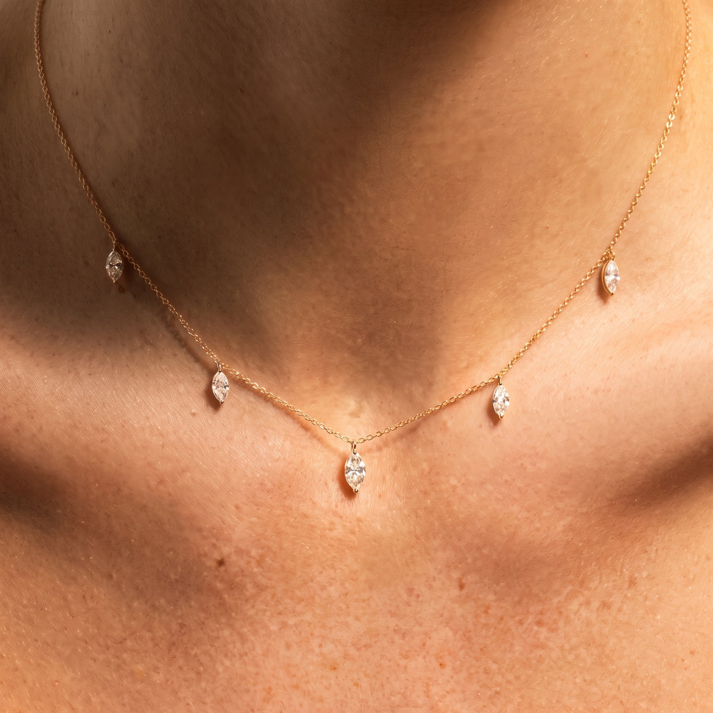 Floating Marquise Diamond Necklace worn at the collarbone in golden hour light