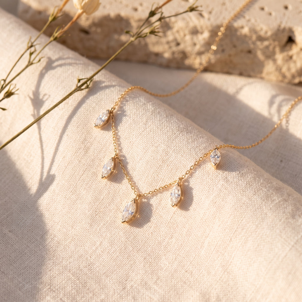 Floating Marquise Diamond Necklace on raw linen with dried stems and Jerusalem stone