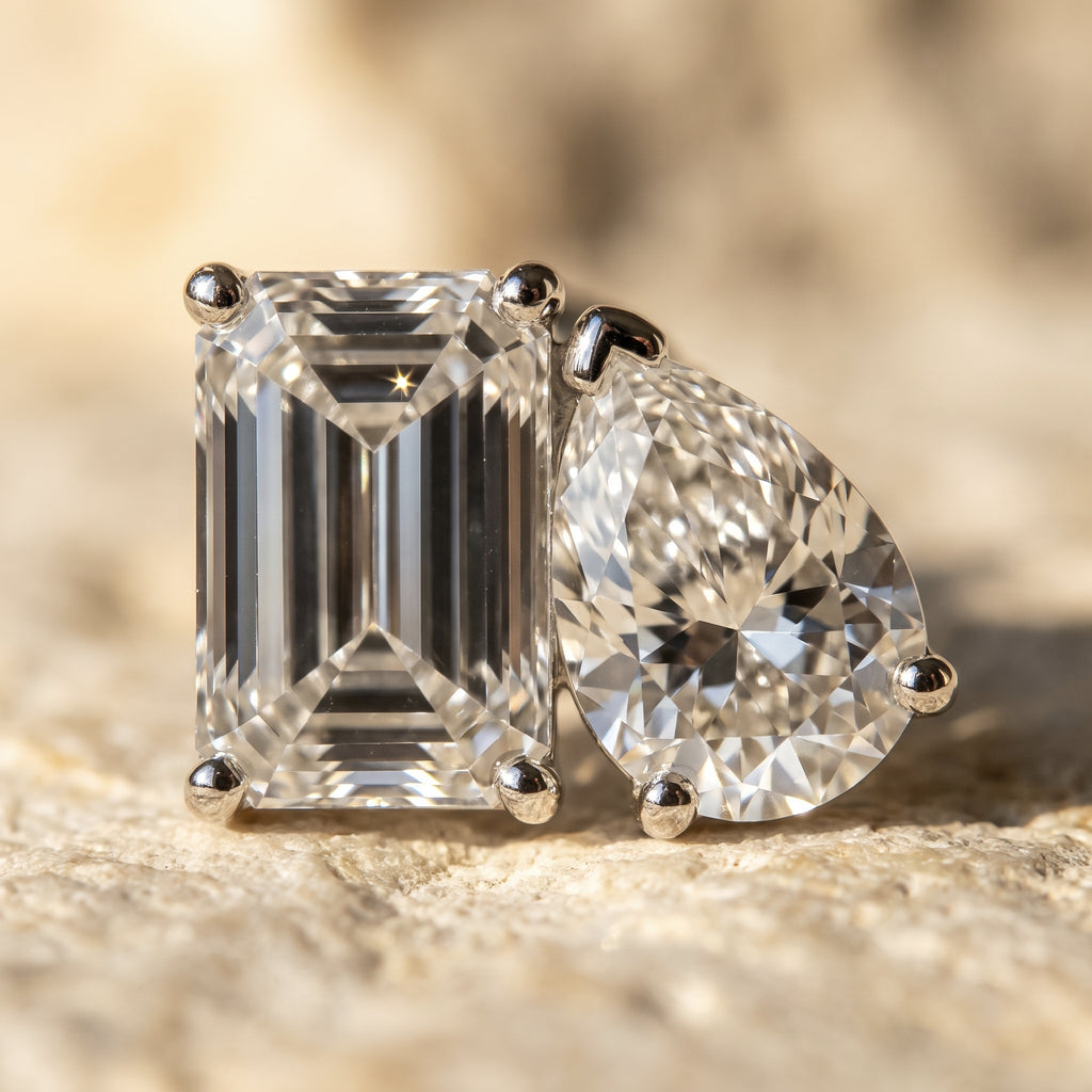 Macro detail of Rachel's Vow toi-et-moi stud: emerald-cut and pear diamonds in bead-set 14k white gold