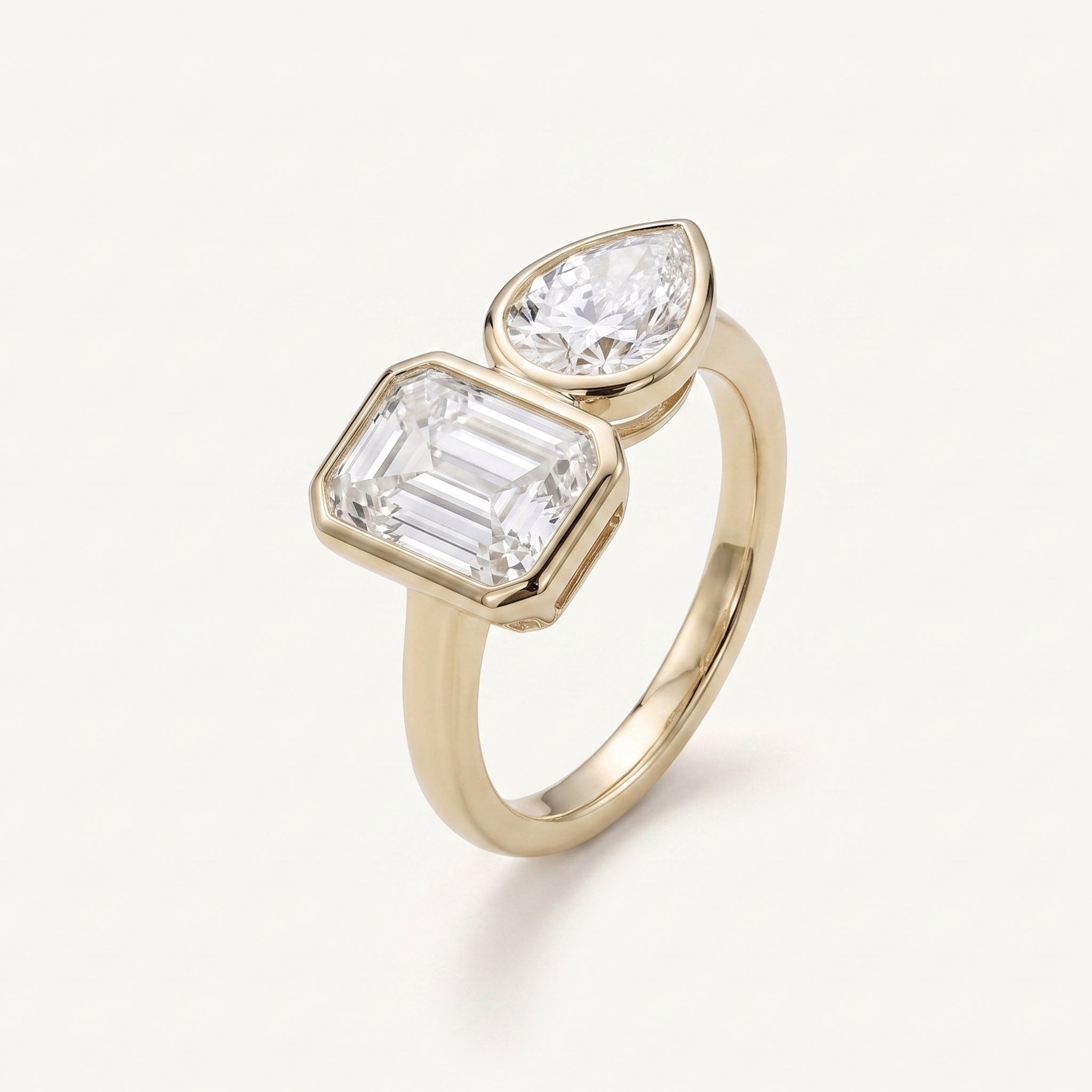 Rachel's Vow Ring emerald cut and pear toi-et-moi ring in 14k gold