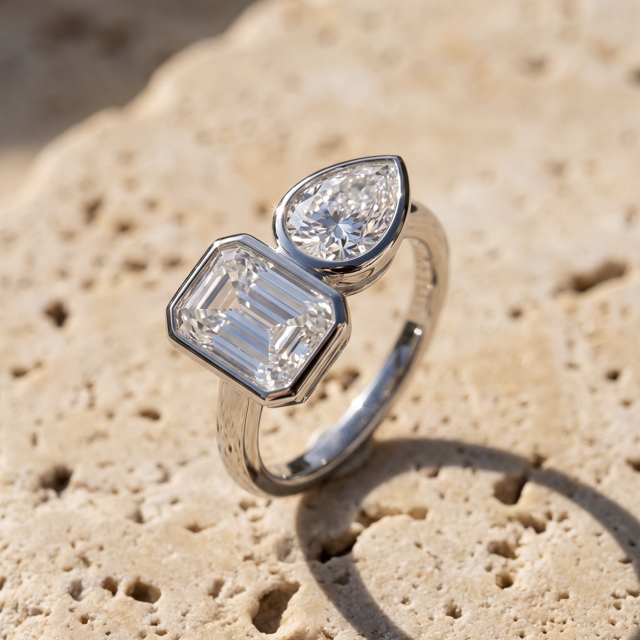 Rachel's Vow Ring toi-et-moi with bezel-set emerald cut and pear in 14k white gold on raw Jerusalem stone