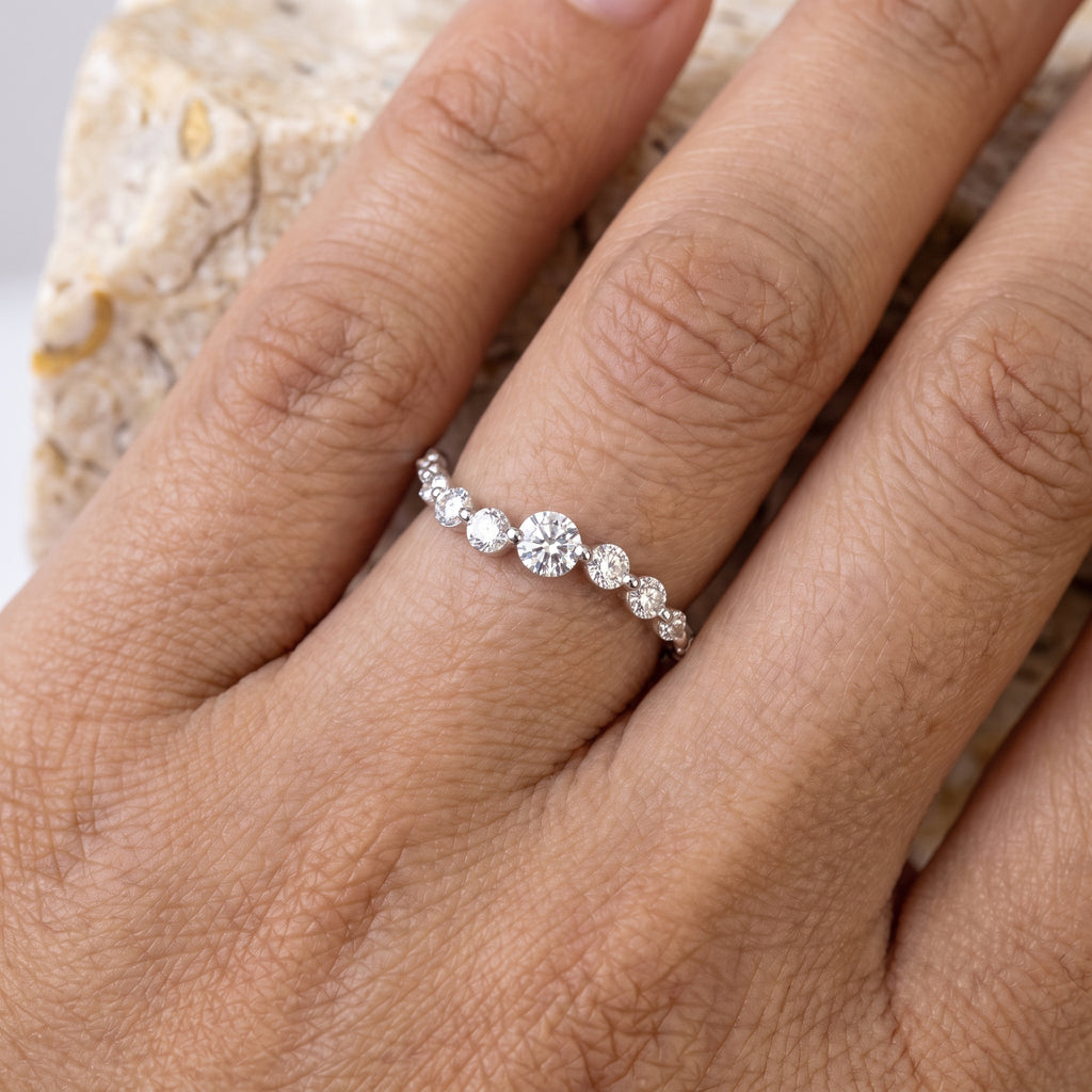 Rebecca's Water graduated band on hand against travertine