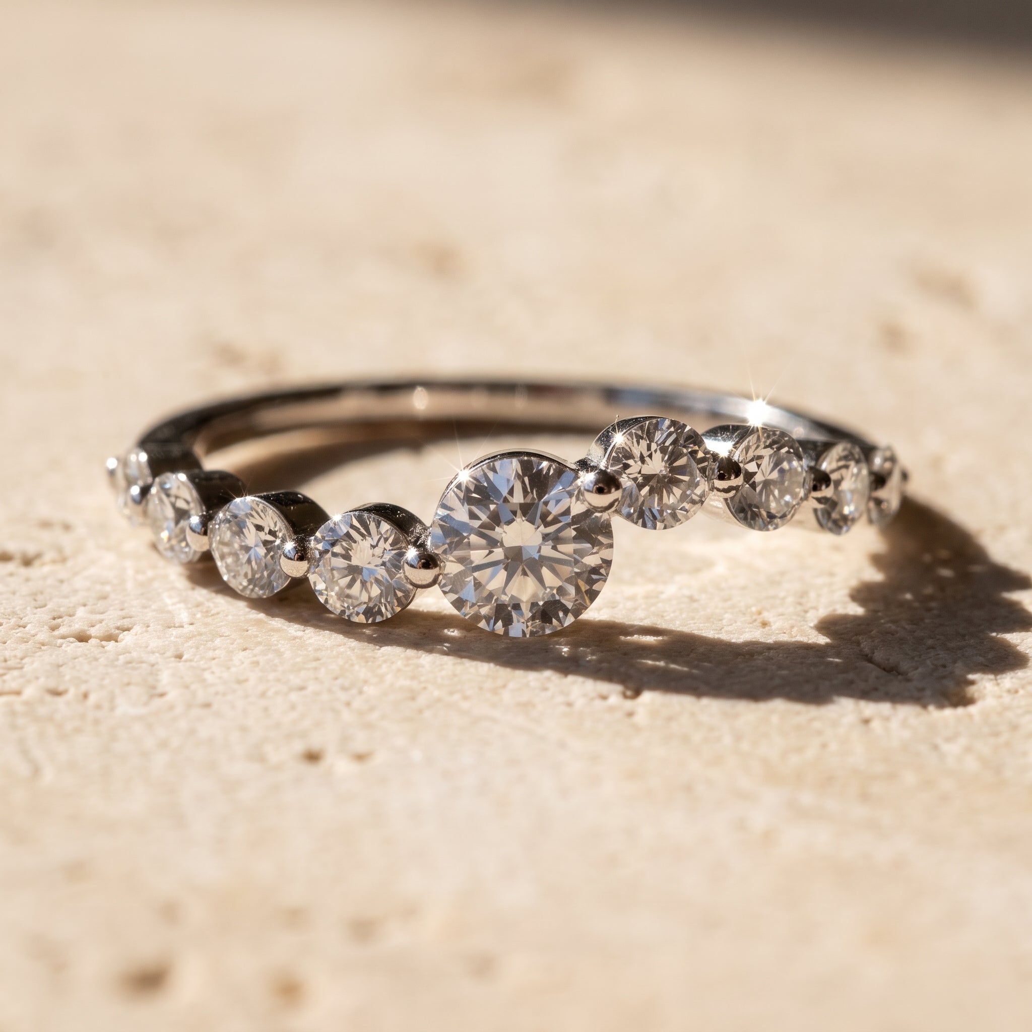 Rebecca's Water graduated diamond band on travertine stone