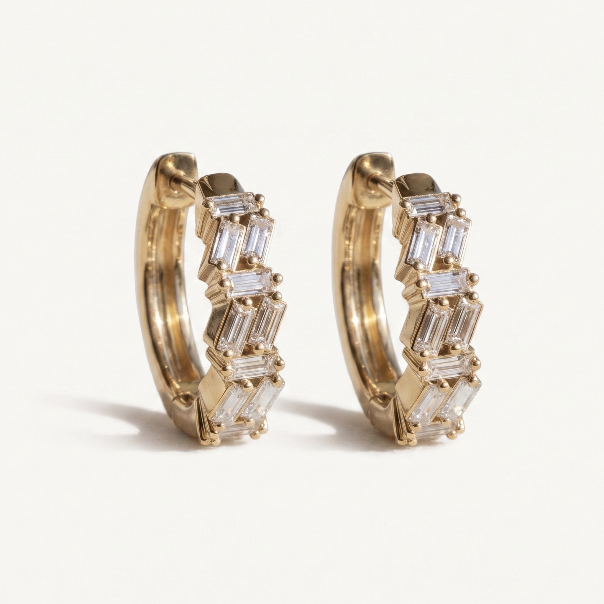 Sarah's Ember scattered baguette diamond hoop earrings in 14k gold