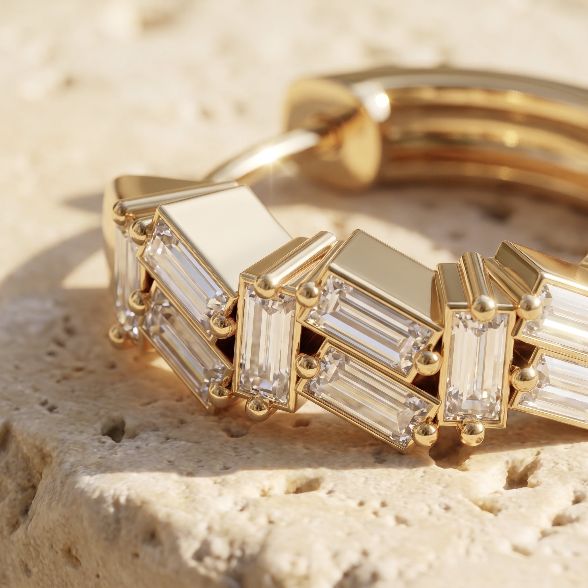 Macro detail of Sarah's Ember: tiny baguette diamonds scattered at varied angles across the polished gold hoop