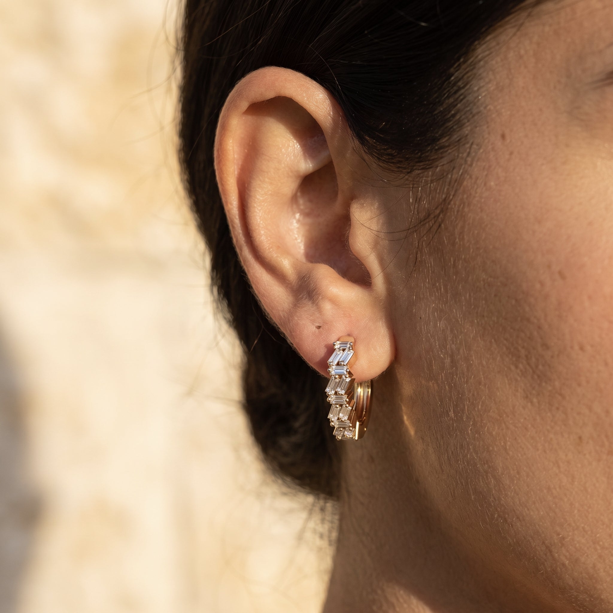 Sarah's Ember huggie hoop worn in the earlobe at true 13mm scale