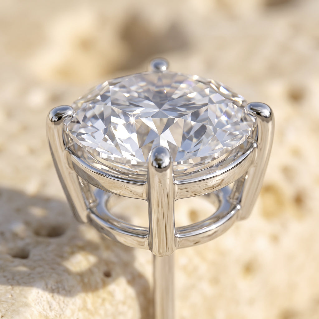 Macro detail of Sarah's Light stud: round brilliant crown facets and four-prong white gold basket