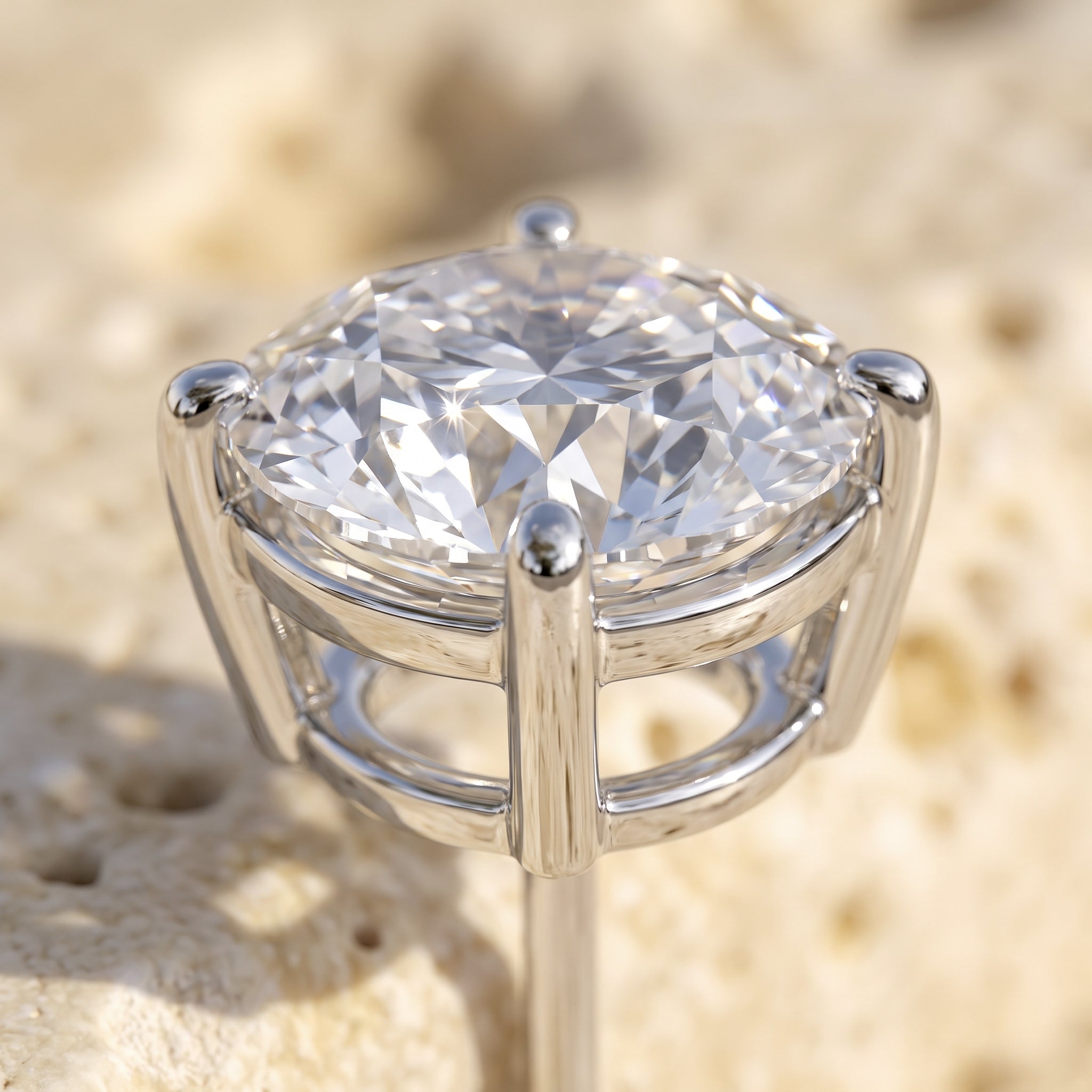 Macro detail of Sarah's Light stud: round brilliant crown facets and four-prong white gold basket