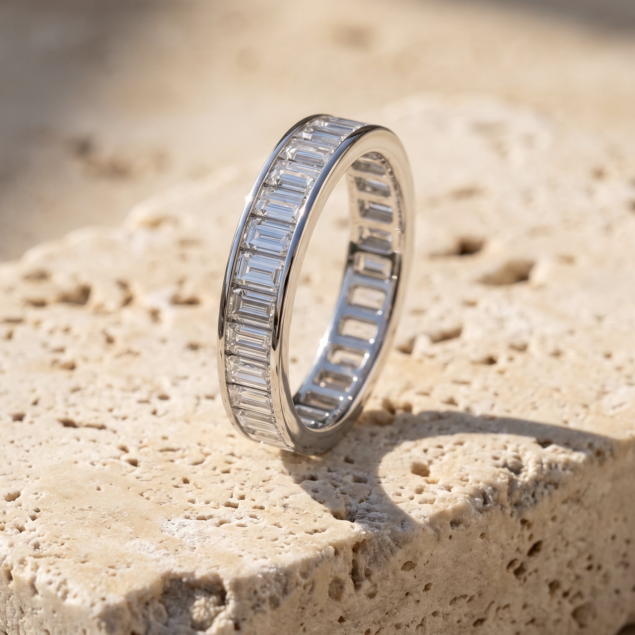 Sarah's Vigil baguette diamond eternity band in 14k white gold on raw Jerusalem stone