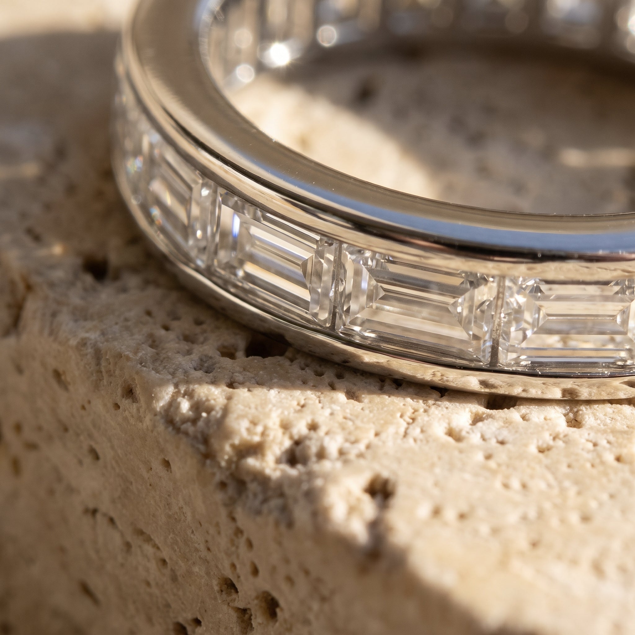Macro detail of Sarah's Vigil: channel-set baguettes with step-cut facets in an unbroken line