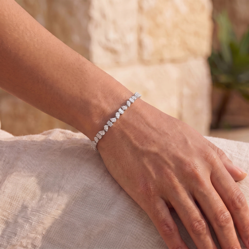 The Emora Tennis Bracelet worn on the wrist in warm daylight